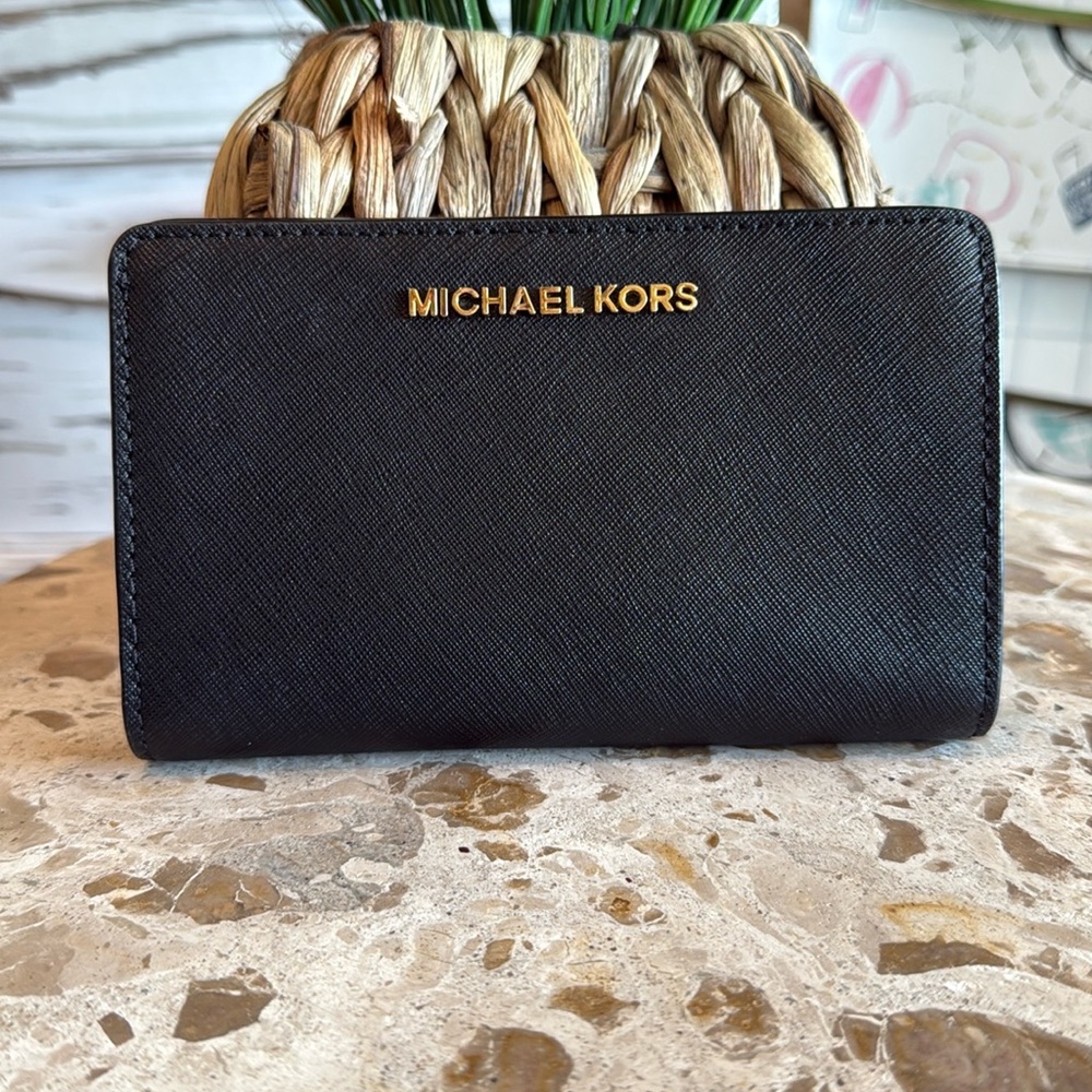 Michael Kors black saffiano leather with snap closure. New w/o tags, never used.
